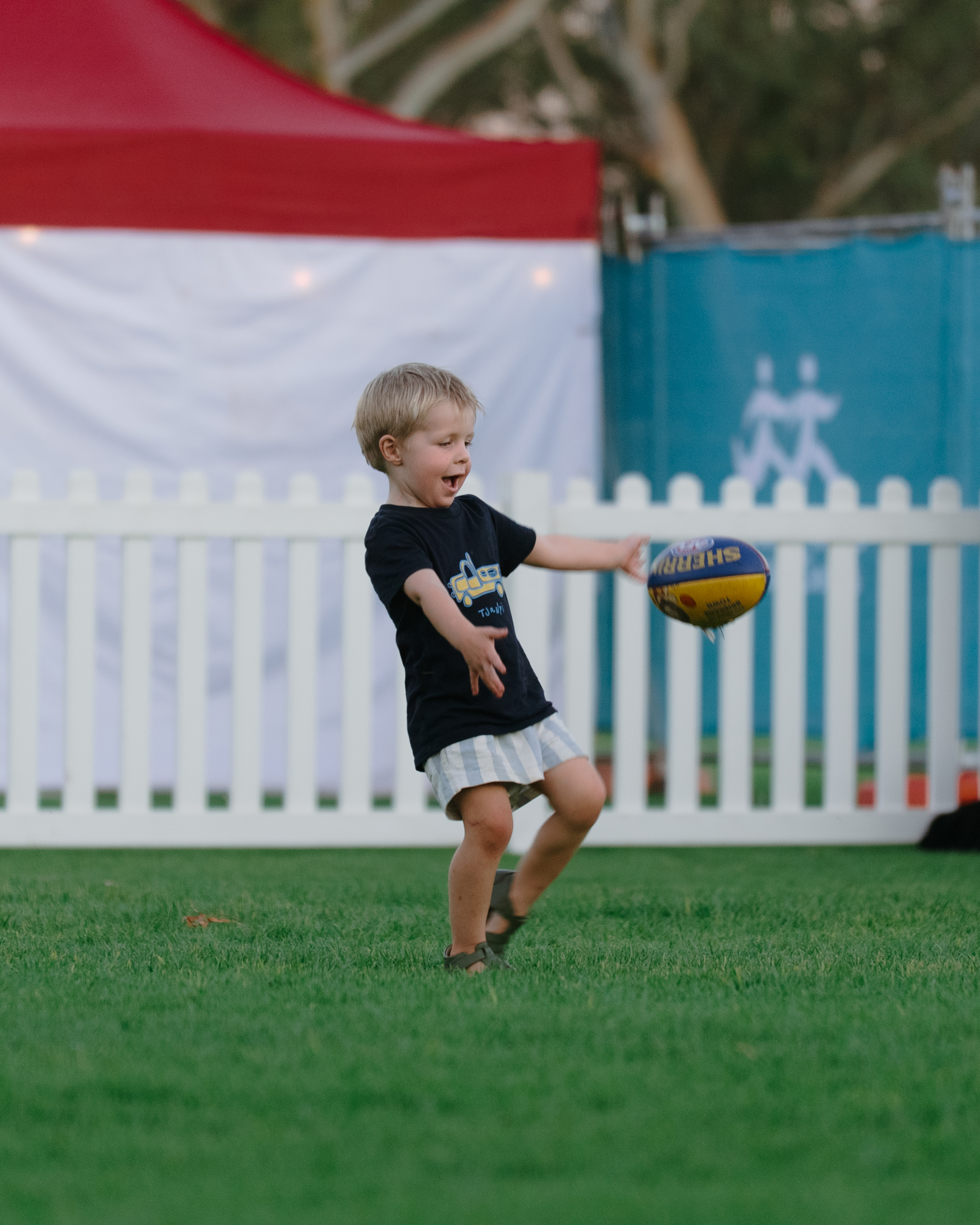 A young sports fan kicks a ball at the Alice Springs Masters Games 2026
